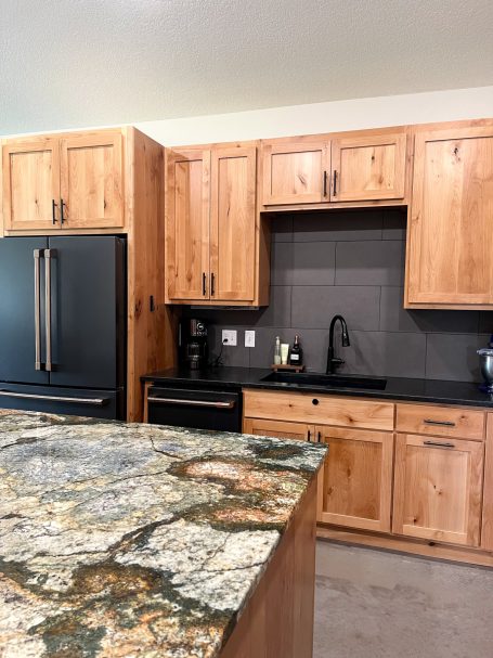 New kitchen cabinets with contrasting black backsplash built by the Amish.